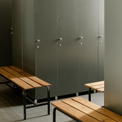 Locker room with wooden benches and lockers.