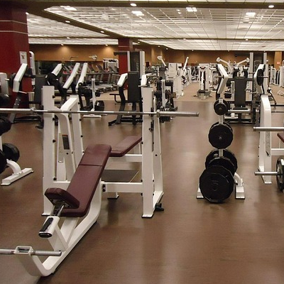 Weight room filled with dumbbells and weight machines.